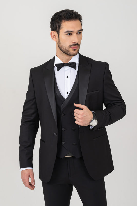 Black tuxedo suit with satin peak lapel.