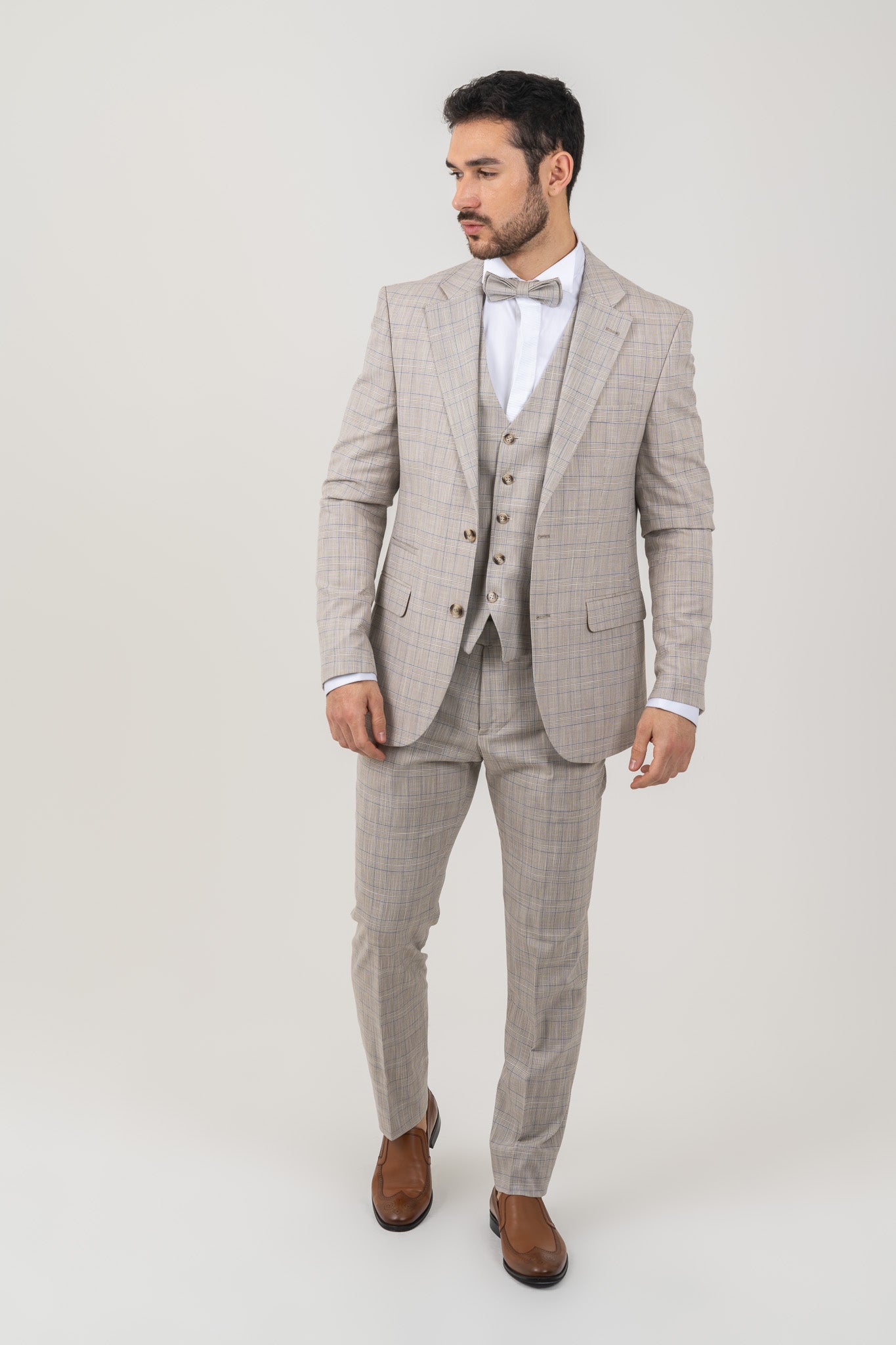 Stylish cross checked pattern on a men's light beige 4 piece suit