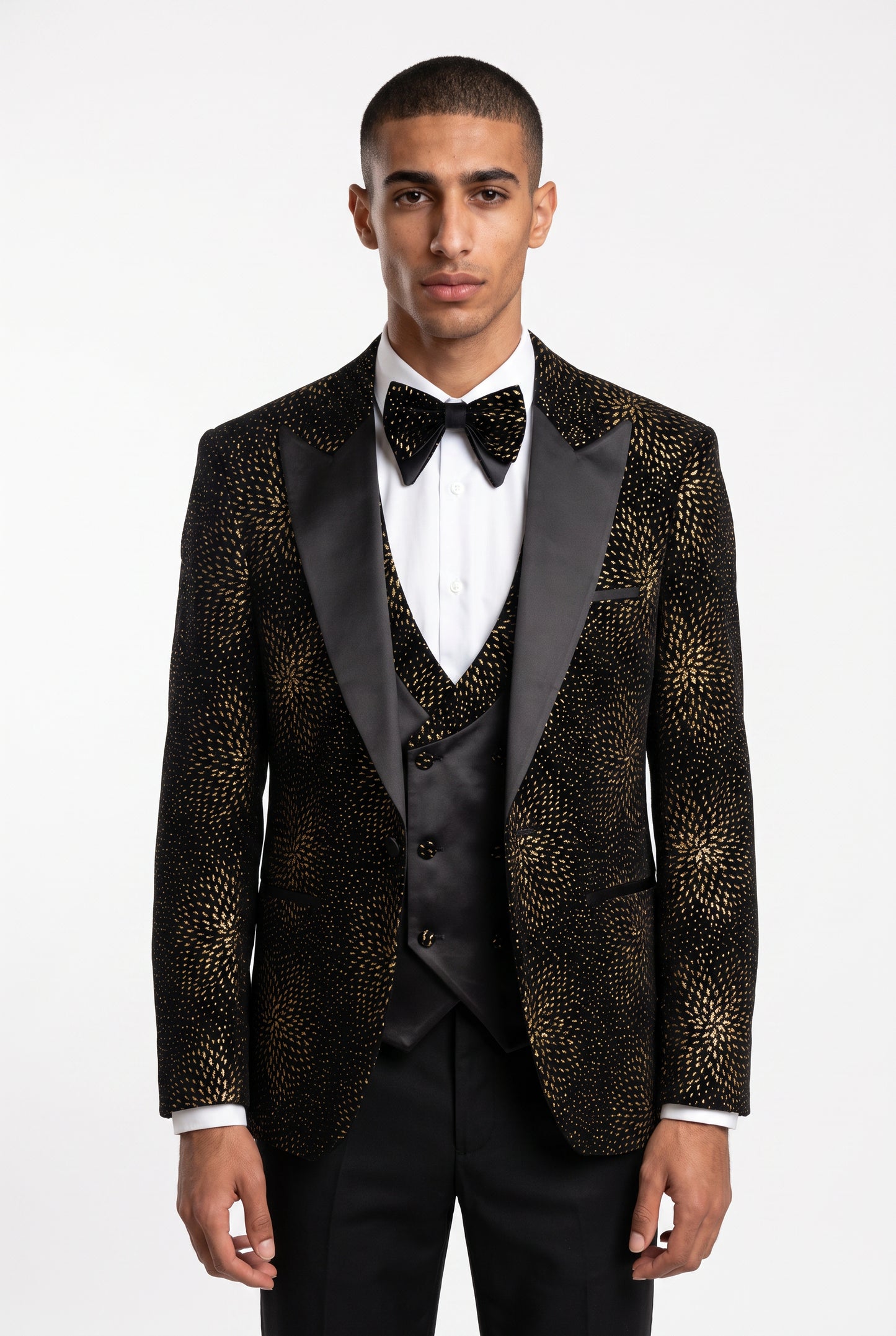 Man wearing a gold starburst velvet tuxedo with a satin peak lapel and double breasted waistcoat