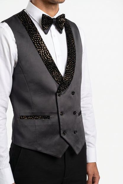 Close view of the double breasted satin waistcoat and matching gold bow tie