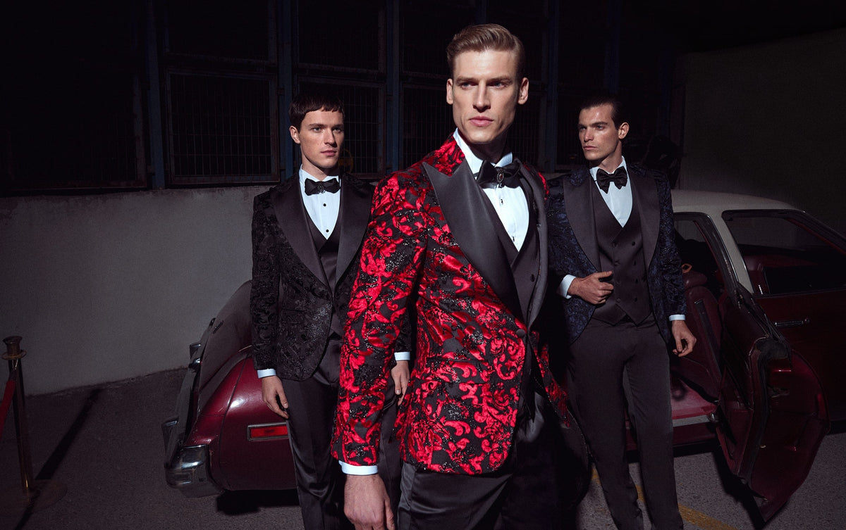 Men in red, navy and black patterned tuxedos with bow ties, styled for Christmas party season. Jacquard and patterned.