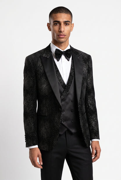 Man wearing a silver starburst velvet tuxedo with a satin peak lapel and double breasted waistcoat