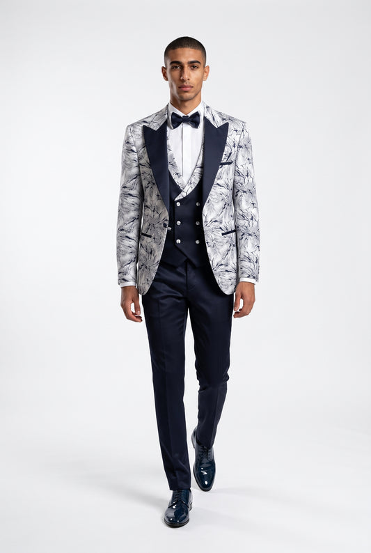 Man wearing a white lightning print tuxedo with a navy satin peak lapel, navy trouser full view